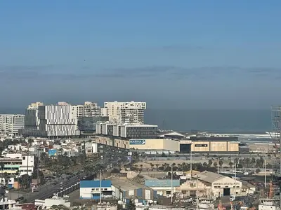 a city with tall buildings and the ocean at Melines in Casablanca