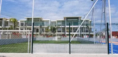 a tennis court in front of a building at CASA BAY BEACH RETREAT in Sidi Rahal