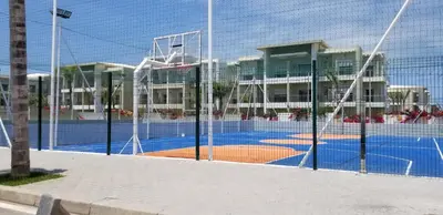 a tennis court in front of a building at CASA BAY BEACH RETREAT in Sidi Rahal