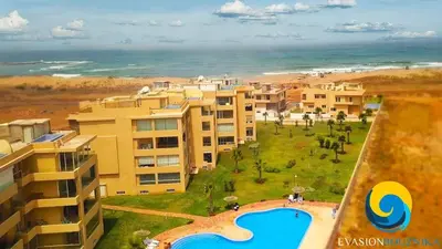 an aerial view of a resort with a swimming pool and the ocean at Sea View Luxury Apartment Just Steps from the beach in Bouznika