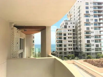 a balcony with a view of a large building at Beautiful View on the sea at Casa-Marina 13 in Casablanca
