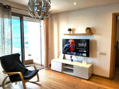 a living room with a tv and a chair at Beautiful View on the sea at Casa-Marina 13 in Casablanca