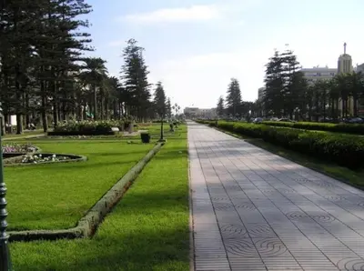 a walkway in a park with green grass and trees at A 200m de la Plage, du Haut Standing au coeur du Parc in Mohammedia
