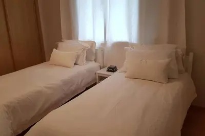 two white beds in a room with a window at A 200m de la Plage, du Haut Standing au coeur du Parc in Mohammedia