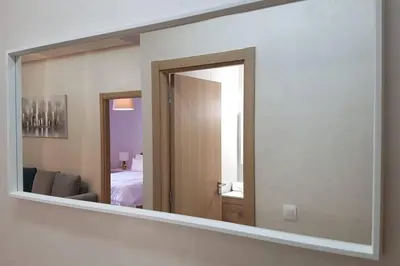 a mirror on a wall in a room at A 200m de la Plage, du Haut Standing au coeur du Parc in Mohammedia