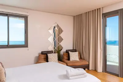 a bedroom with a bed and two chairs and a window at Marina, in a place called: Magnifique !!!!! in Casablanca