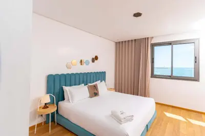a bedroom with a bed with a blue headboard and a window at Marina, in a place called: Magnifique !!!!! in Casablanca