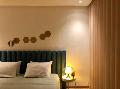a bedroom with a bed with a blue headboard and a lamp at Marina, in a place called: Magnifique !!!!! in Casablanca
