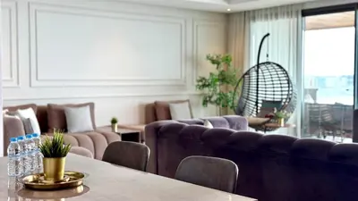 a waiting room with a couch and tables and chairs at Marina, in a place called: Magnifique !!!!! in Casablanca