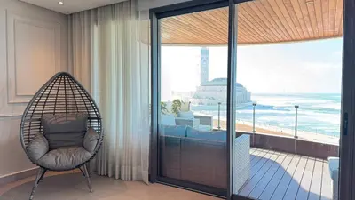 a swing chair in a room with a view of the ocean at KEEP CALM AND THINK OF THE SEA, MARINA!! in Casablanca