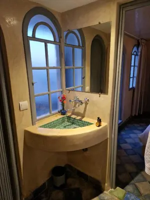 a bathroom with a large sink with a window at L'Oum Errebia in Azemmour