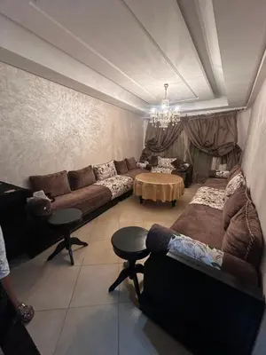 a living room with a couch and a table at Jnane dalia in Bouznika
