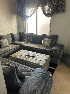 a living room with a couch and a coffee table at Jnane dalia in Bouznika