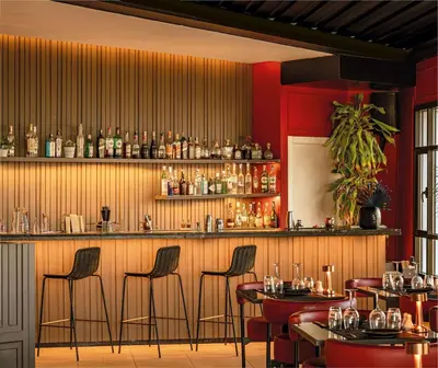 a restaurant with a bar with stools at Radisson Blu Hotel Casablanca City Center in Casablanca