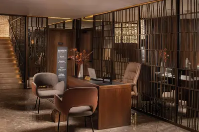 a lobby with a desk and chairs in a building at Radisson Blu Hotel Casablanca City Center in Casablanca