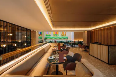 a lobby of a restaurant with tables and chairs at Radisson Blu Hotel Casablanca City Center in Casablanca
