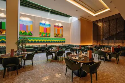 a restaurant with tables and chairs in a room at Radisson Blu Hotel Casablanca City Center in Casablanca