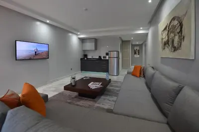 a living room with a couch and a table at Le Yacht Suites Hotel in Casablanca