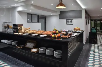 a buffet line with different types of bread and pastries at Le Yacht Suites Hotel in Casablanca