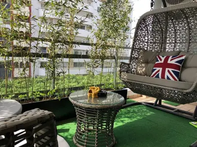 a patio with a chair and a table and a building at City Center Apartment with Terrace in Casablanca