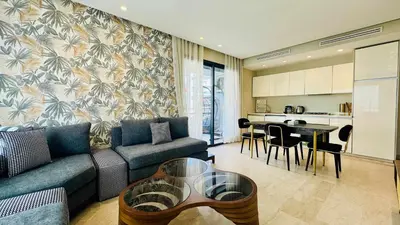 a living room with a couch and a table at City Center Apartment with Terrace in Casablanca