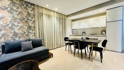 a living room with a couch and a table at City Center Apartment with Terrace in Casablanca