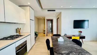 a kitchen and dining room with a table and a stove at City Center Apartment with Terrace in Casablanca