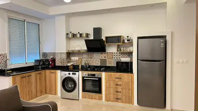 a kitchen with a refrigerator and a dishwasher at Petit nid douillé au coeur de Casablanca in Casablanca