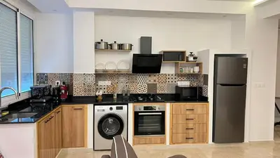 a kitchen with a refrigerator and a dishwasher at Petit nid douillé au coeur de Casablanca in Casablanca