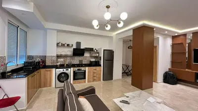 a large kitchen with a couch and a table at Petit nid douillé au coeur de Casablanca in Casablanca