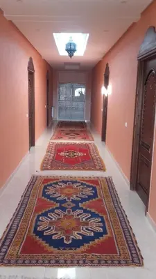 an empty hallway with two rugs on the floor at Riad TANJIL in Casablanca