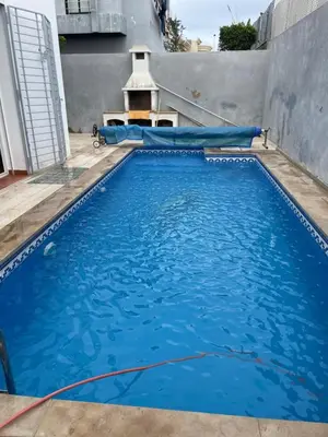 a large blue swimming pool with a water slide at Luxury Villa at Ain-Diab in Casablanca