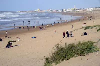 a group of people walking on a beach at Luxury Villa at Ain-Diab in Casablanca