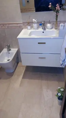 a bathroom with a white sink and a toilet at Appartement de luxe in Casablanca