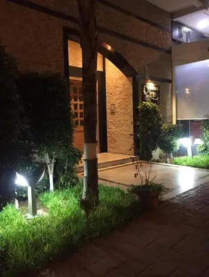 a building with a tree in a courtyard at night at Appartement de luxe in Casablanca