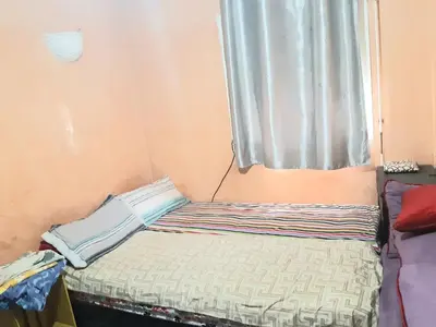 a small bed in a room with a window at Aznavour room in Casablanca