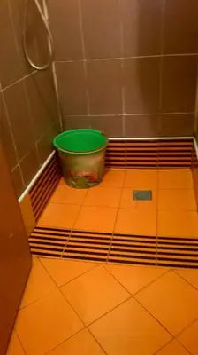 a bucket sitting on the floor of a bathroom at Aznavour room in Casablanca