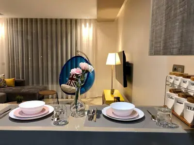 a table with plates and a vase of flowers on it at Luxury Top Floor, Casablanca Center... in Casablanca