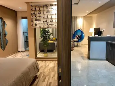 a bedroom with a bed and a living room at Luxury Top Floor, Casablanca Center... in Casablanca
