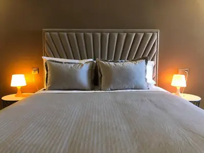 a bedroom with a large bed with two lamps at Luxury Top Floor, Casablanca Center... in Casablanca