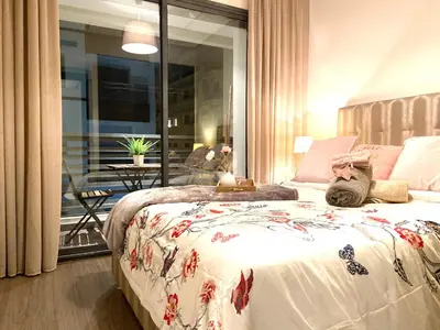 a bedroom with a bed with a cat laying on it at Best in Town - Central -Comfortable-in Racine in Casablanca