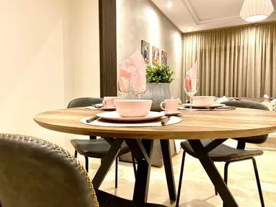 a wooden table in a room with chairs around it at Best in Town - Central -Comfortable-in Racine in Casablanca