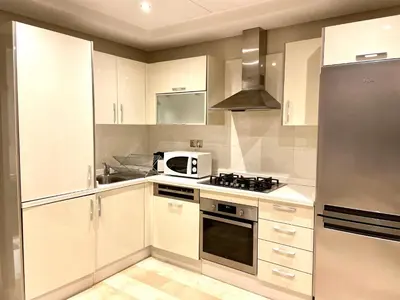 a kitchen with white cabinets and a stove top oven at Best in Town - Central -Comfortable-in Racine in Casablanca
