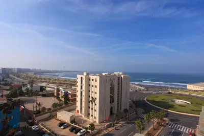 an aerial view of a large white building next to the ocean at Mosquee & Sea View Casablanca in Casablanca