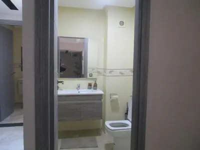 a bathroom with a toilet and a sink and a mirror at Mosquee & Sea View Casablanca in Casablanca