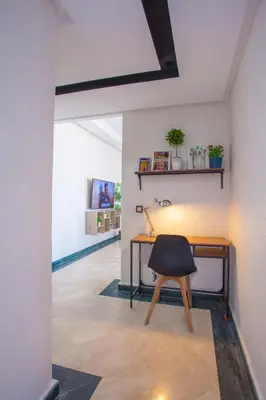 a desk with a black chair in a room at Mosquee & Sea View Casablanca in Casablanca