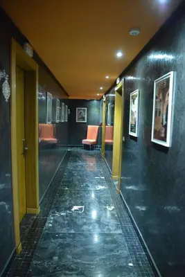 an empty hallway with a chair in a building at Aralia Boutique Hôtel in Rabat