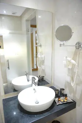 a bathroom with a white sink and a mirror at Aralia Boutique Hôtel in Rabat