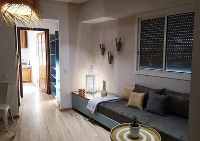 a living room with a couch and a table at LAU 09 Studio Terrasse in Rabat