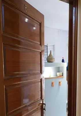 a wooden door in a room with a shelf at LAU 09 Studio Terrasse in Rabat